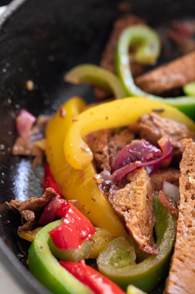 A close shot of a skillet with vegan fajitas