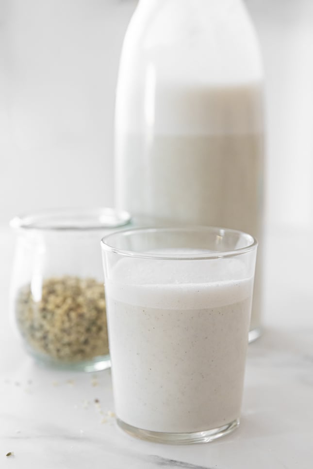 Side shot of a glas and a bottle of hemp milk