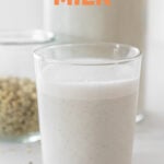 Side shot of a glass of hemp milk with the words hemp milk